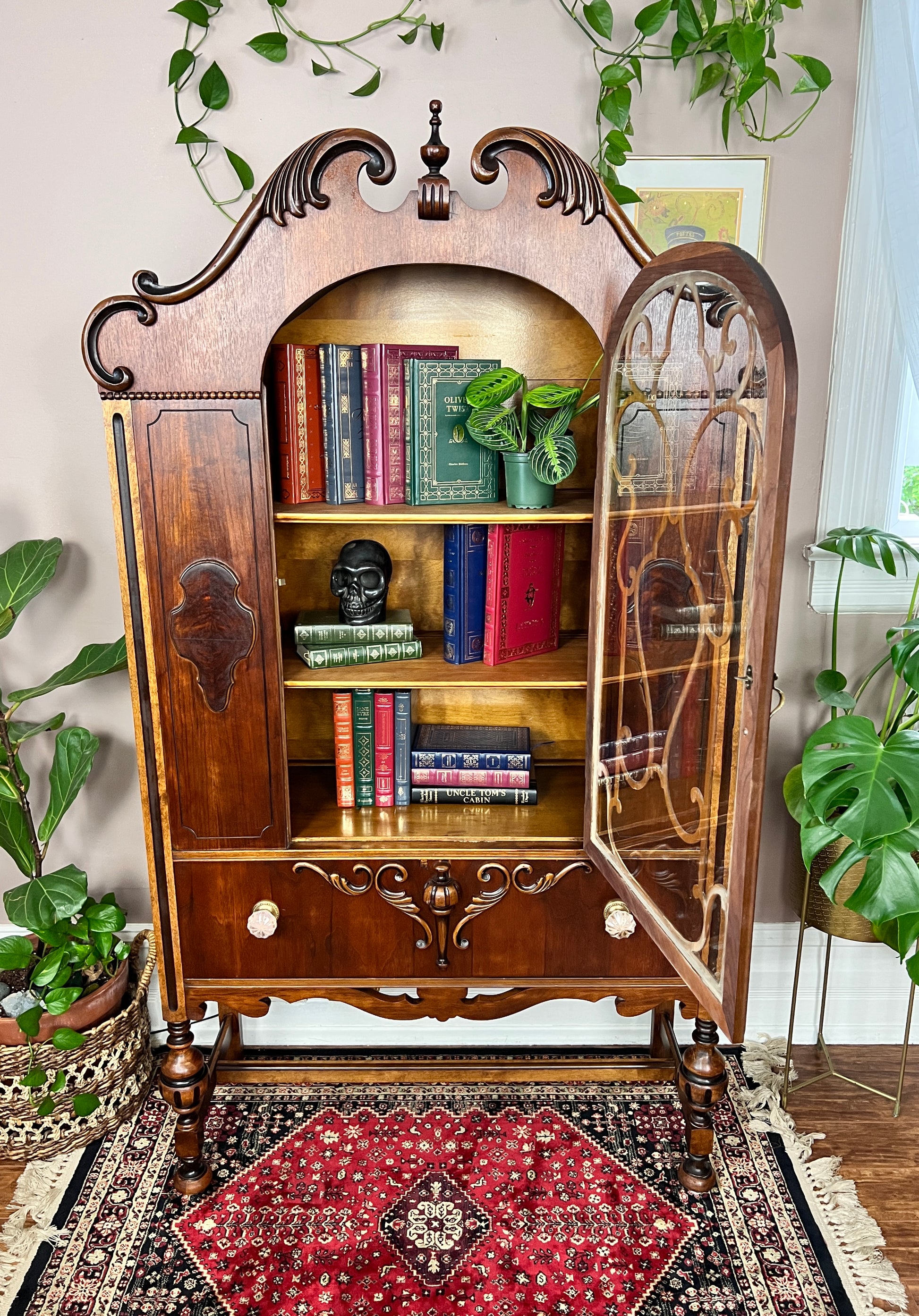This is an antique china cabinet made from solid walnut wood.