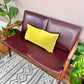 This is a vintage walnut 60s loveseat bench with burgundy vinyl upholstery.