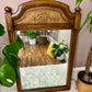 This is a vintage solid oak mirror