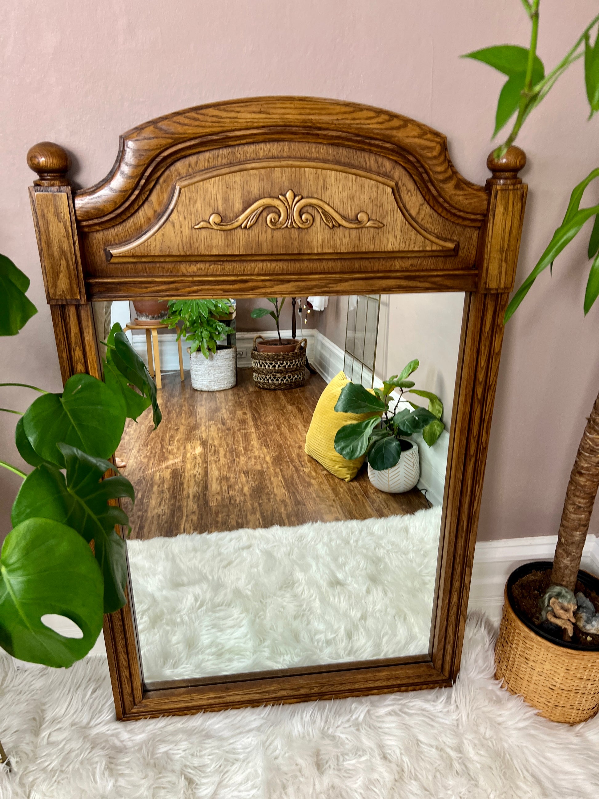 This is a vintage solid oak mirror